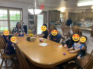 Children playing bingo at a cottage at Sunny Glen Children's Home
