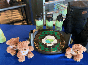 Awards, sponsor gifts, and keepsakes displayed at a previous FORE! The Kids Topgolf Classic, highlighting community support through charity sponsorship for children at Sunny Glen.
