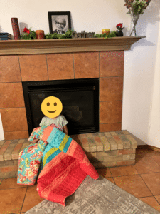 Child at Sunny Glen Children’s Home with a colorful donated blanket, representing the power of trauma-informed support for children