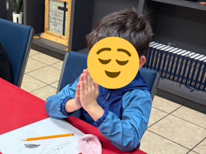 child praying during a Bible study session at Sunny Glen Children’s Home