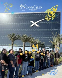 Sunny Glen Children's Home youth and staff pose for a group photo outside the SpaceX building.