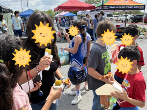 Sunny Glen children enjoying pizza and snacks at an outdoor spring festival, representing the heart behind Mental Health Awareness Month.