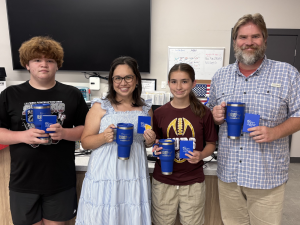 Team 'Here for the Snacks' celebrates their win at Sunny Glen's Sixth Annual Trivia Night, a charity trivia night fundraiser benefiting foster youth in Harlingen, Texas