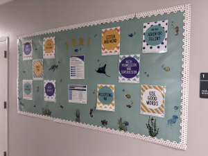 Colorful bulletin board with trauma-informed behavior guides displayed at the Poenisch Counseling Center, where family counseling near me is available.