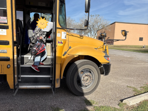 Child stepping off a bus after a day at school, illustrating the link between foster care and education