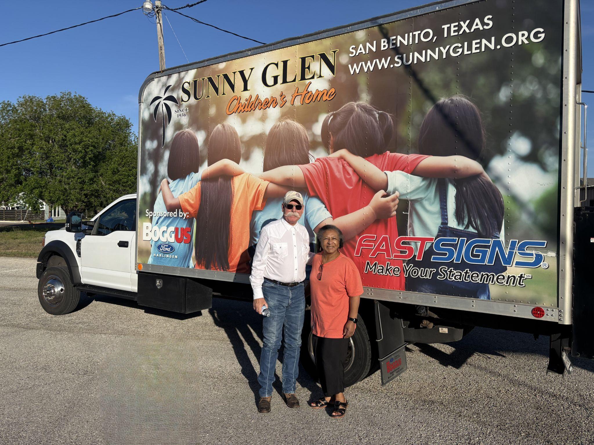 Sunny Glen campus minister Mr. Scott Pinkerton stands next to a member of Ingleside Church of Christ, one of the stops during the Sunny Glen Truck Route